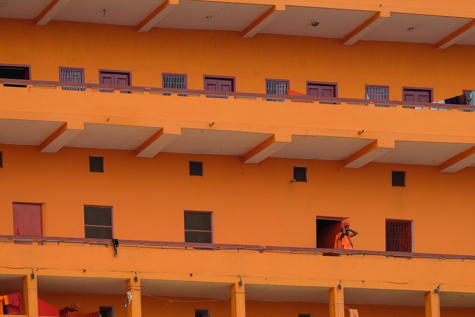Monk Dressed in Orange Living in an Orange Building