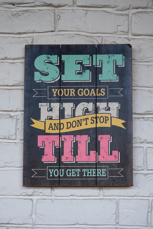 Inspirational Quote in Picture Frame Hanging on a Brick Wall