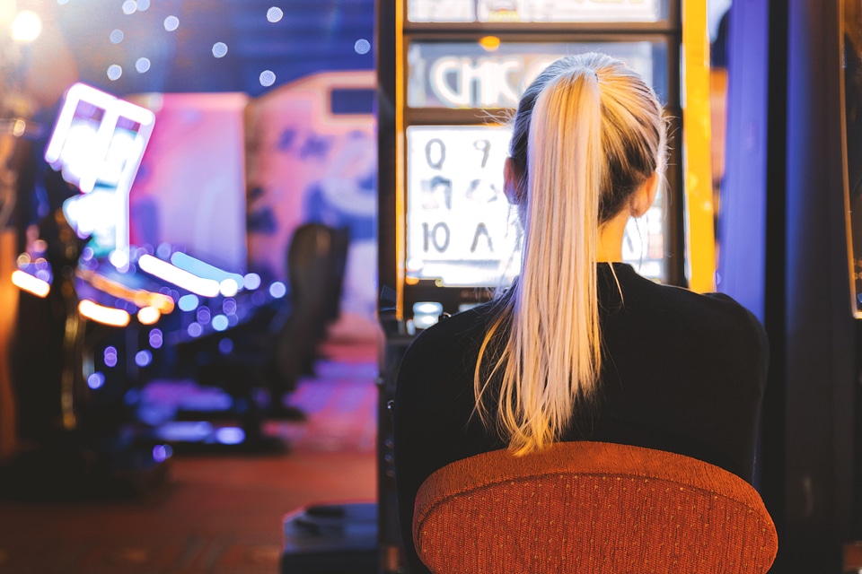 2 Young woman playing at slot machine in casino