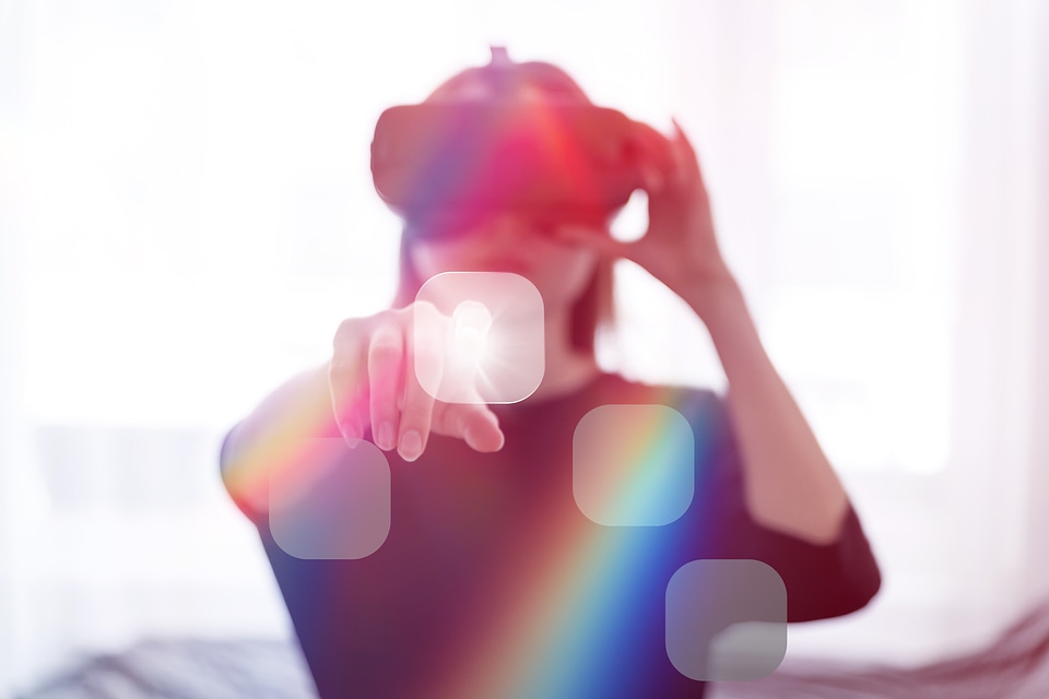1 Woman wearing virtual reality goggles in her modern studio