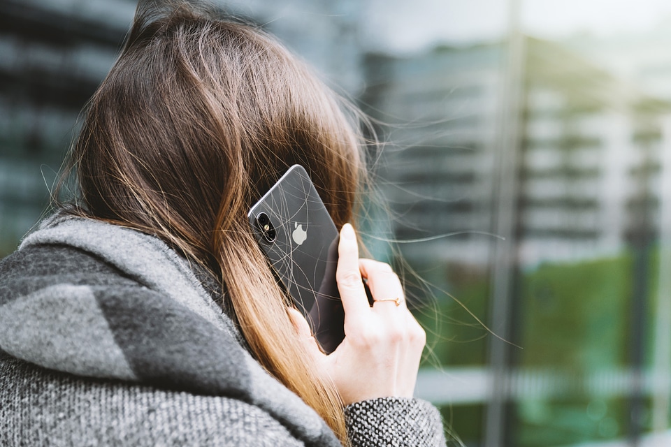 Woman talking on cell phone, back view photo