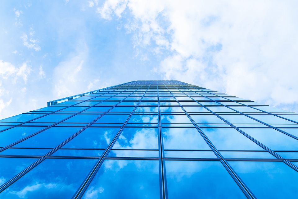 Sky with clouds in the reflection in windows of modern office building photo