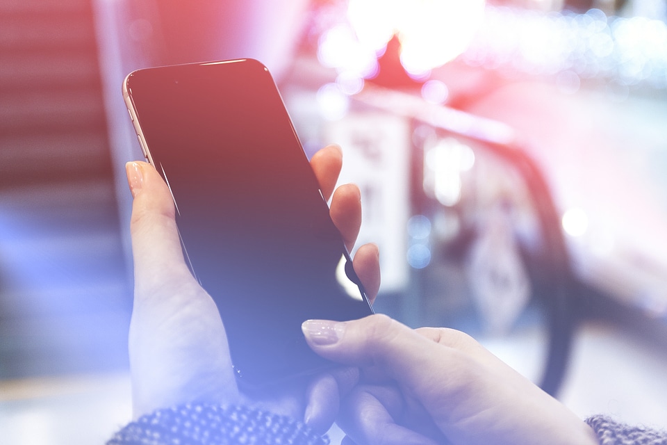 Modern smartphone in the women hands. Unlock phone with finger print