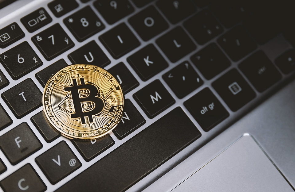 One golden bitcoin on keyboard