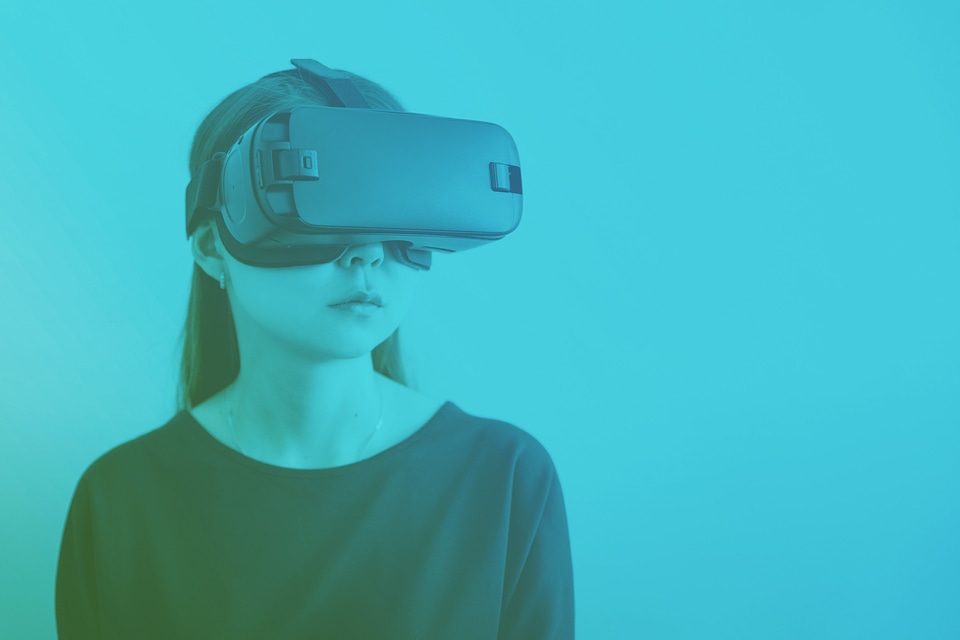 Woman wearing virtual reality goggles.