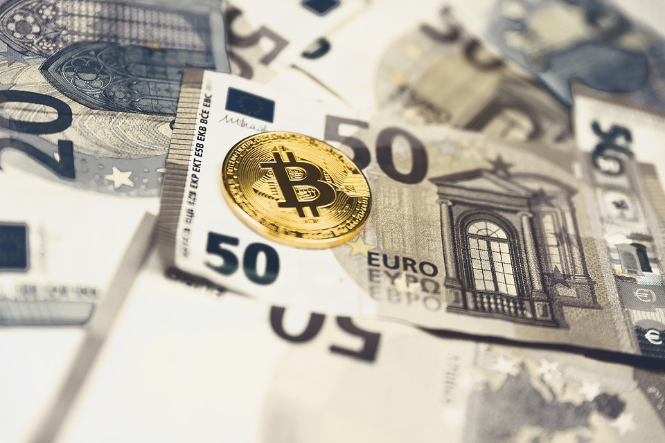 2 Golden bitcoin Euro background. Bitcoin cryptocurrency.