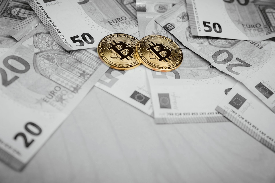 2 Bitcoins and euros, money and currency exchange rate concept