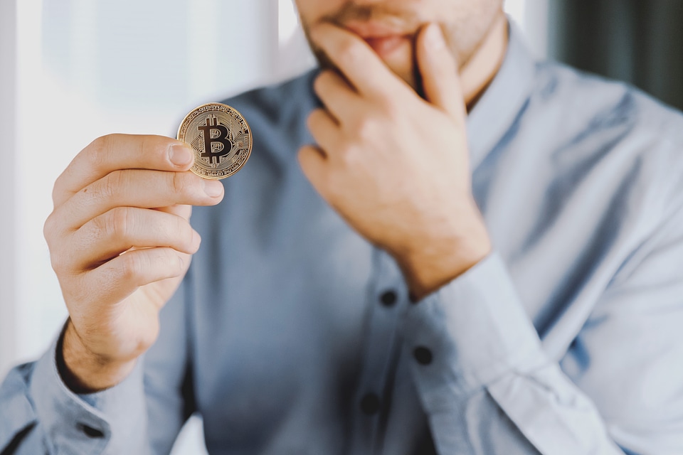 2 Cryptocurrency golden bitcoin coin in man hand