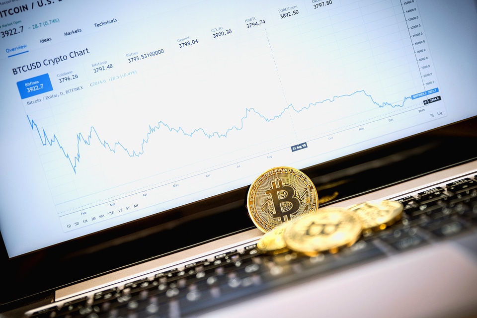 Golden Bitcoin coin on the laptop keyboard