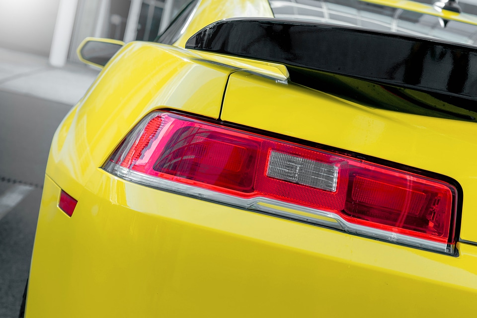 Rear light of yellow luxury car. Close up