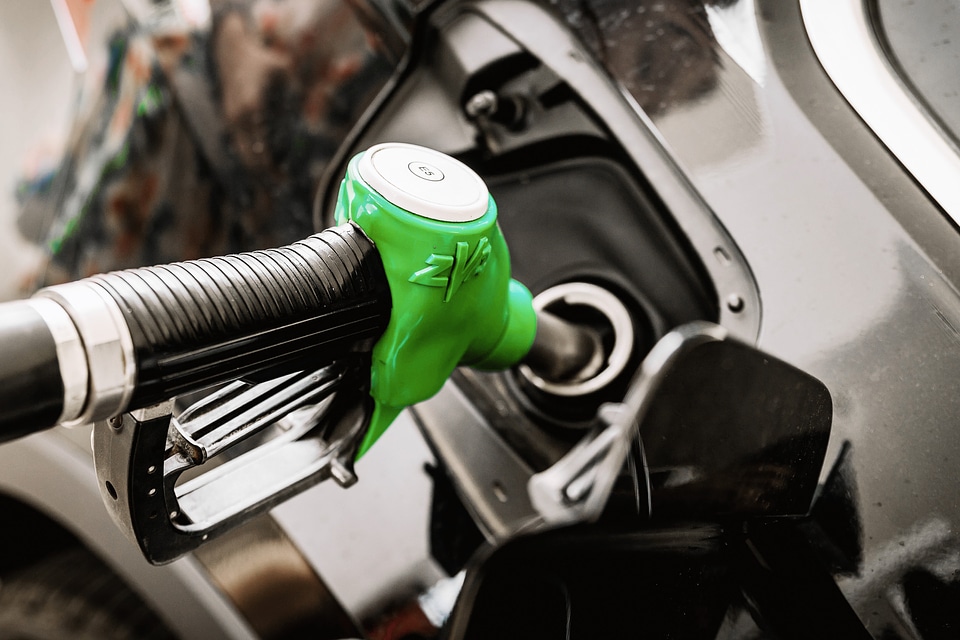 Pumping gas at gas station.
