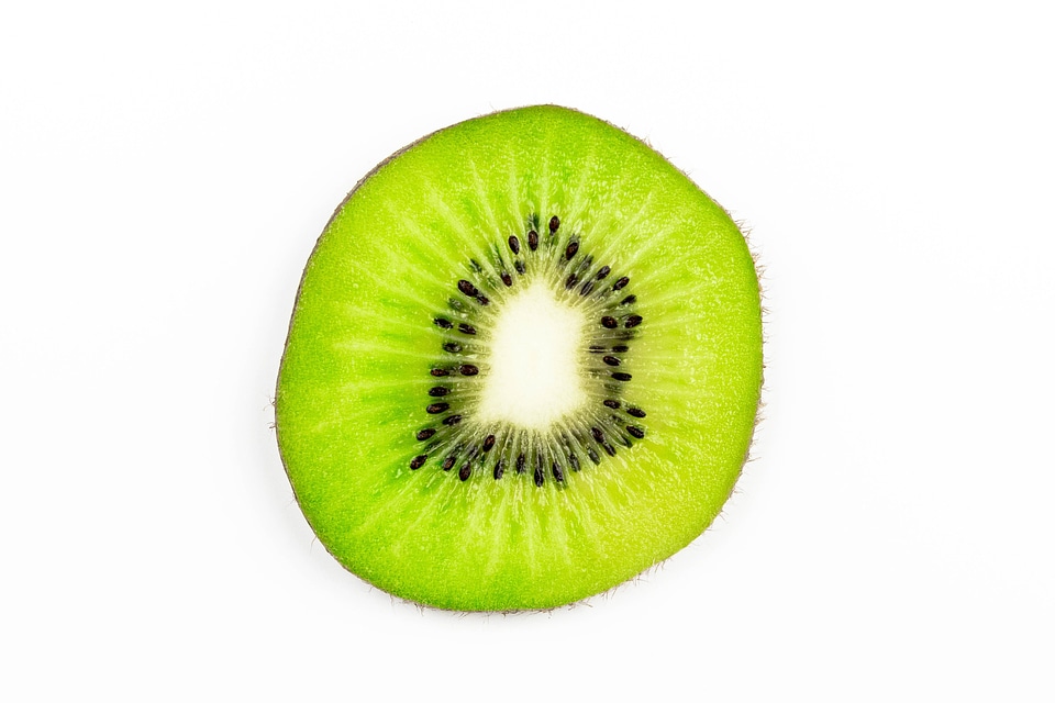 Slice of kiwi fruit isolated on white background
