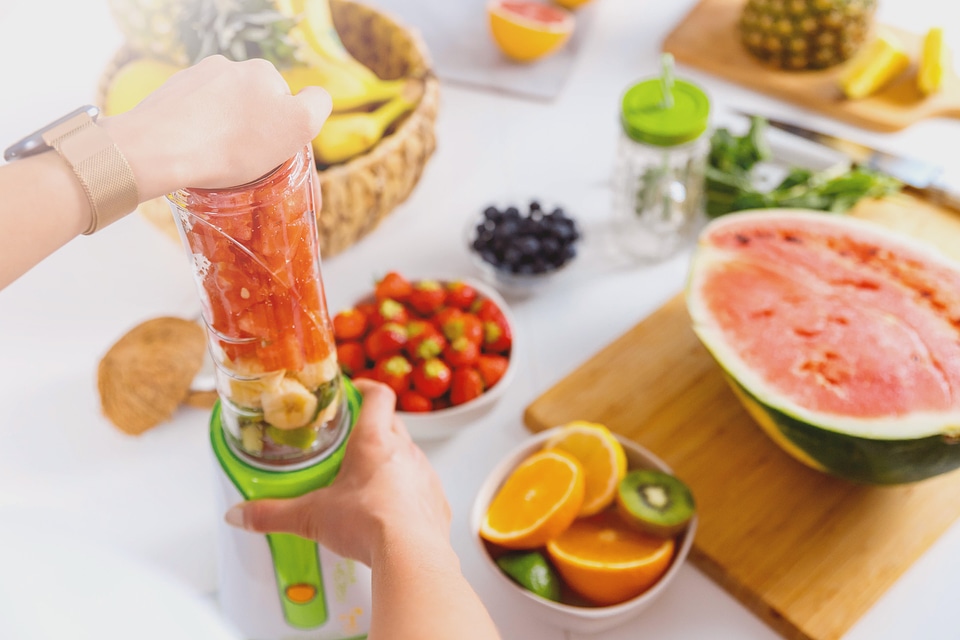 1 Hands of woman preparing smoothie fruit drink