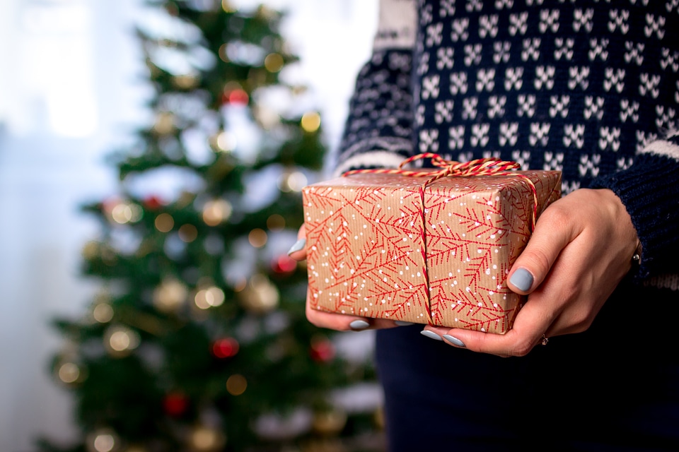 1 Woman’s hands hold christmas gift box. Merry Christmas
