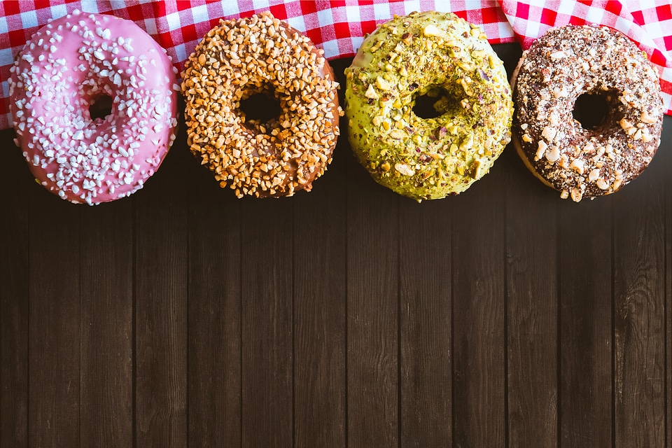Four fantastic American donuts on a wooden table
