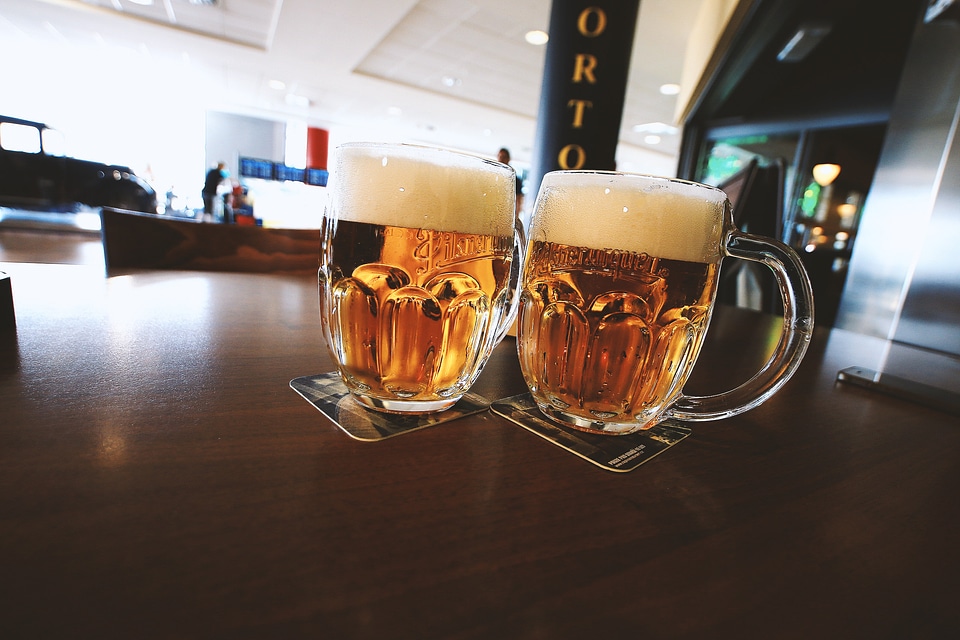 Two glasses of beer on a wooden table