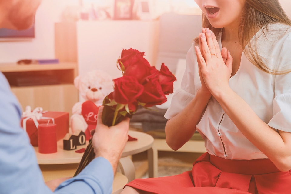 Man gives roses to woman
