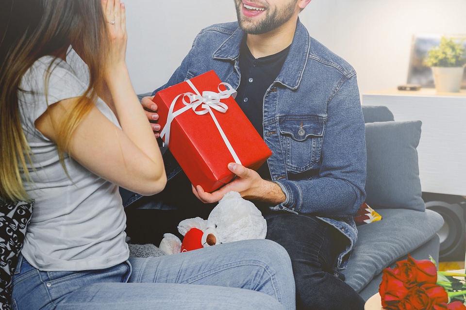 The guy gives a gift box to his girlfriend