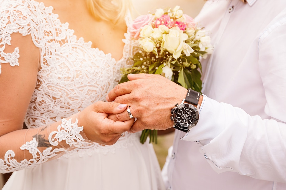 Close up Bride Put the Wedding Ring on groom. Romantic atmosphere