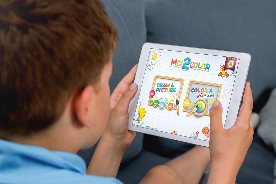 A little boy is educating on the tablet at home