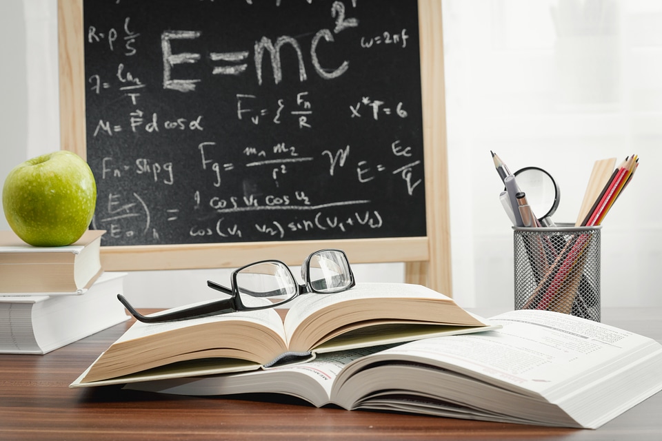 School books on desk, education concept