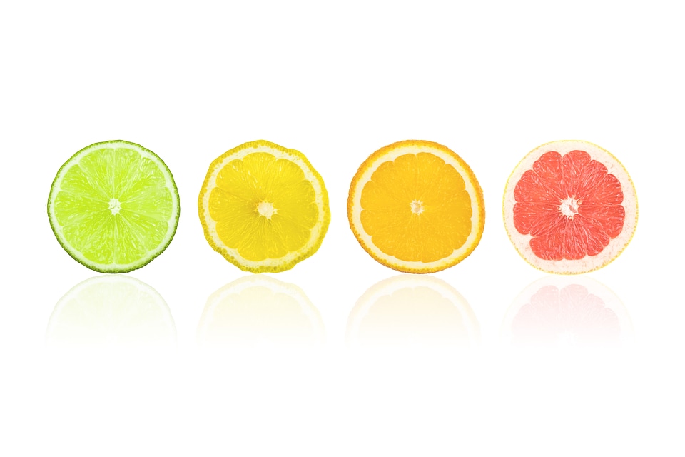 Citrus slices fruits isolated on white. Pieces fresh of orange, lime, lemon, grapefruit in row. photo