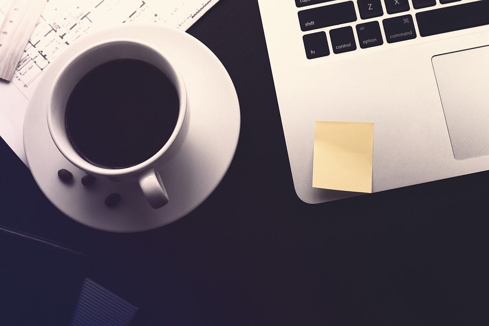 Work desk. Coffee, documents and laptop