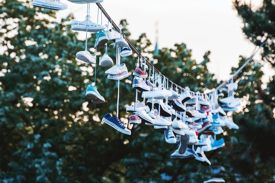 Shoes hanging on a line at city park. Prague, CZE