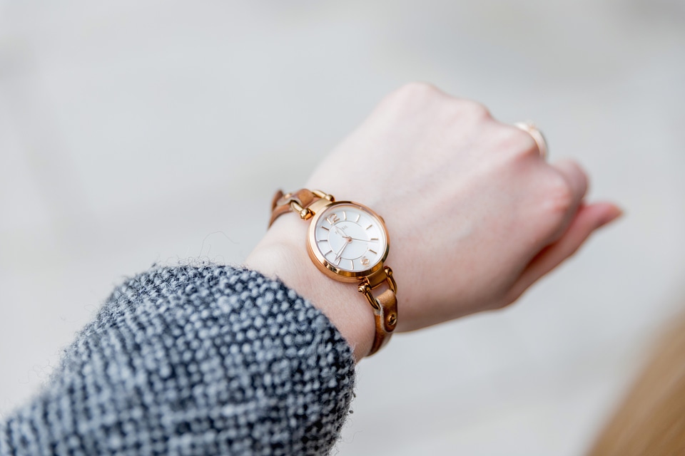 Woman with clock checks the time