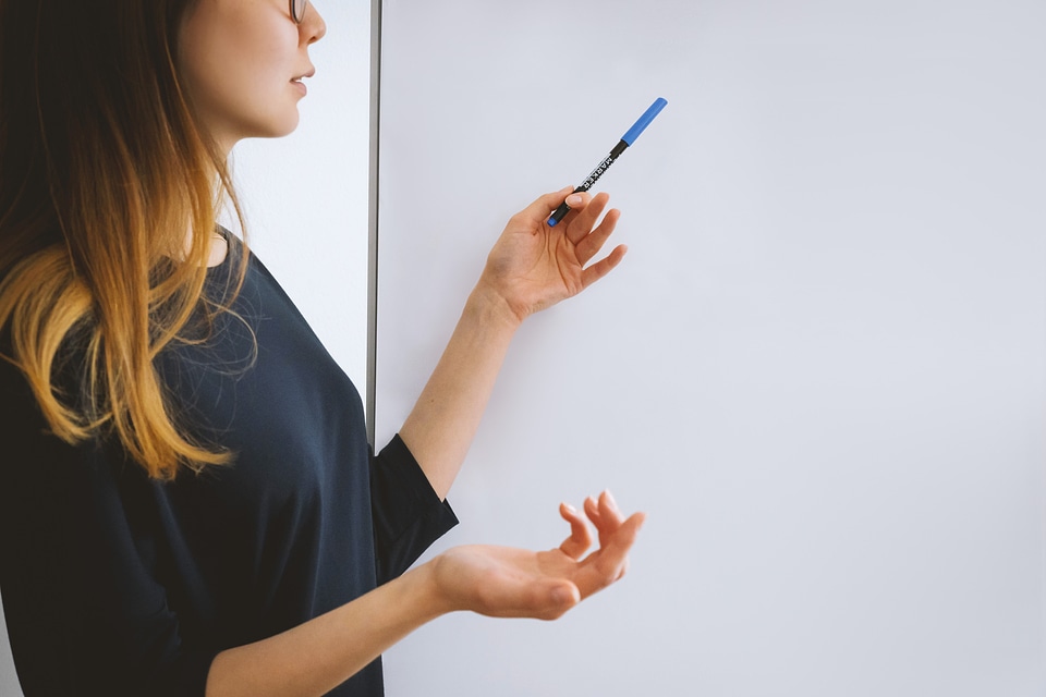 Female coach giving presentation in meeting room