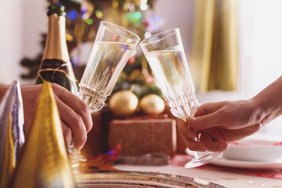Female and male hands toasting with glasses of champagne