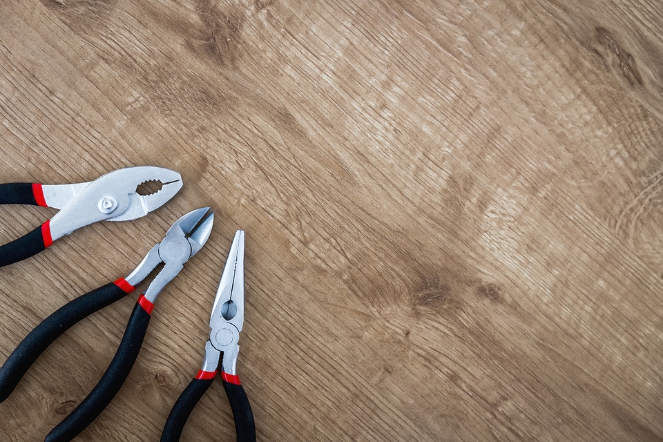 2 Set of pliers tools on wooden board