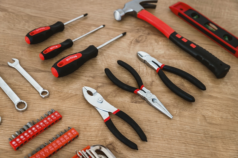 2 Construction tools on the wooden background.