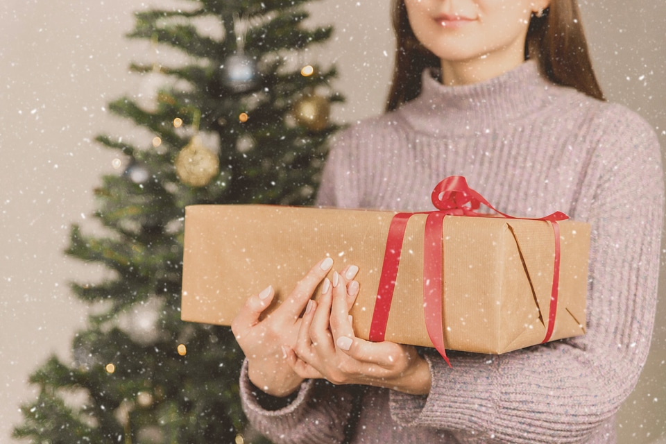 1 Young girl holds Christmas presents. Merry Christmas