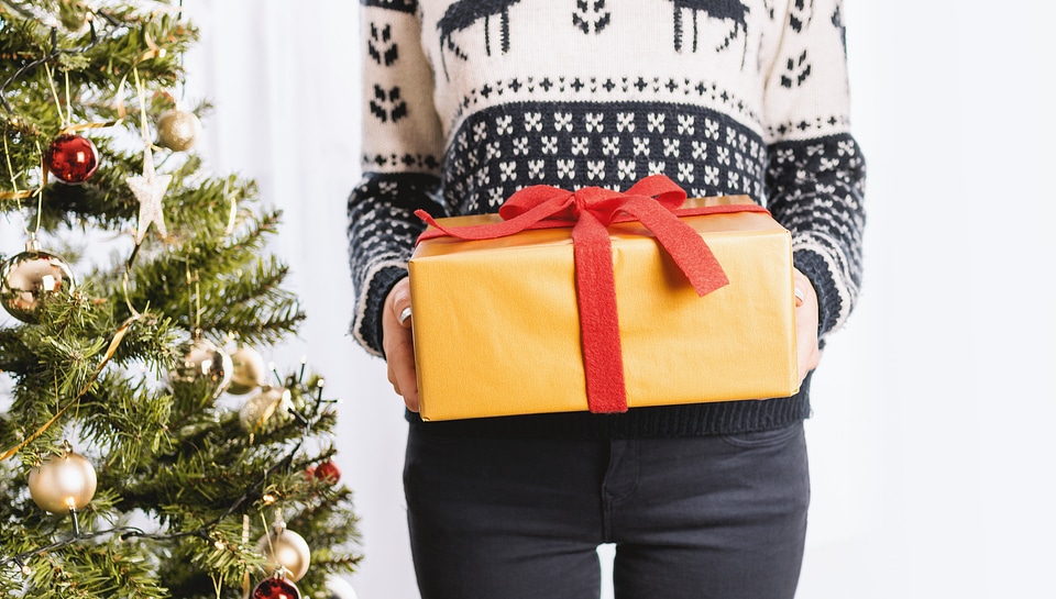 2 Young girl holds Christmas presents. Merry Christmas