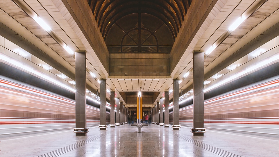 Metro station and two underground train in motion