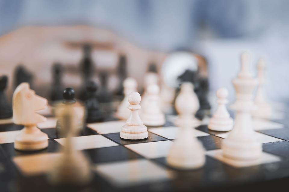 3 Young businessman playing chess in the office