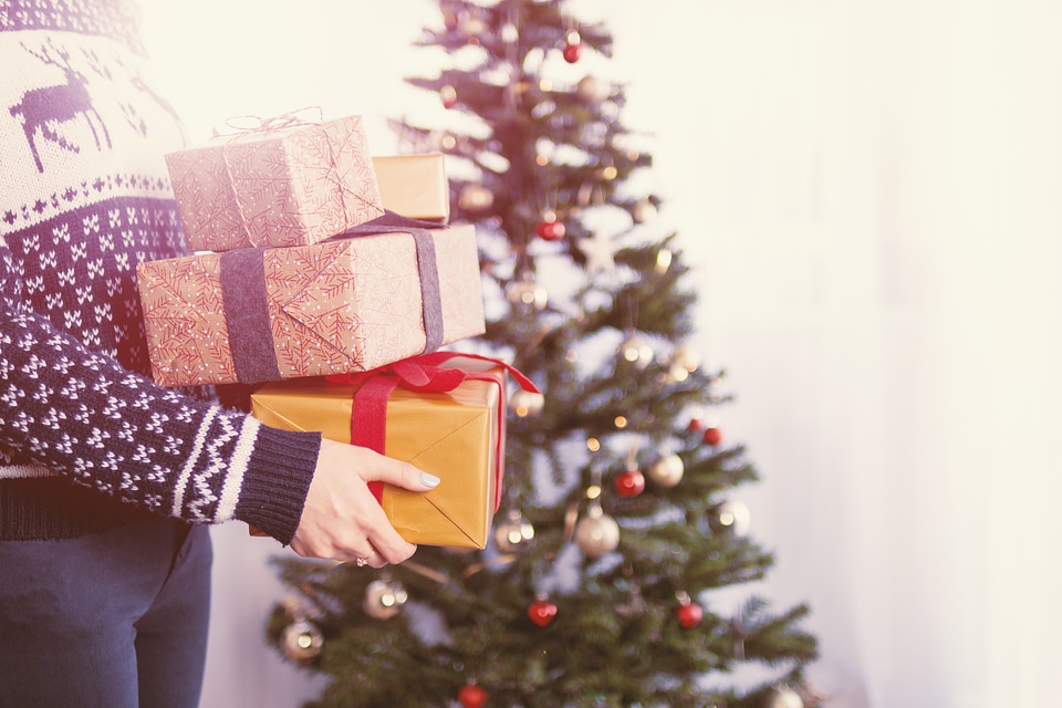 Woman’s hands hold christmas gift boxes. Merry Christmas photo