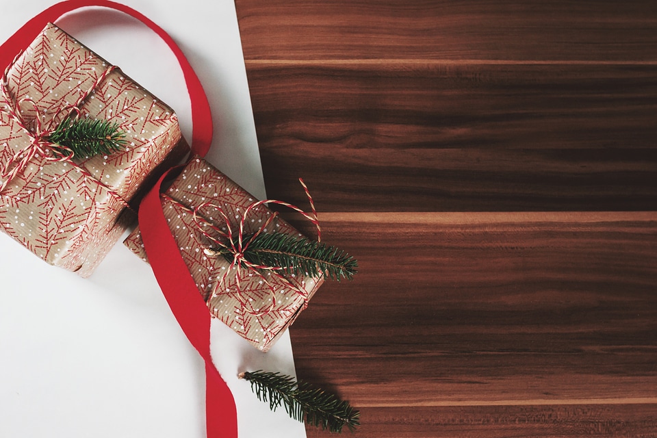 Christmas presents laid on a wooden table background