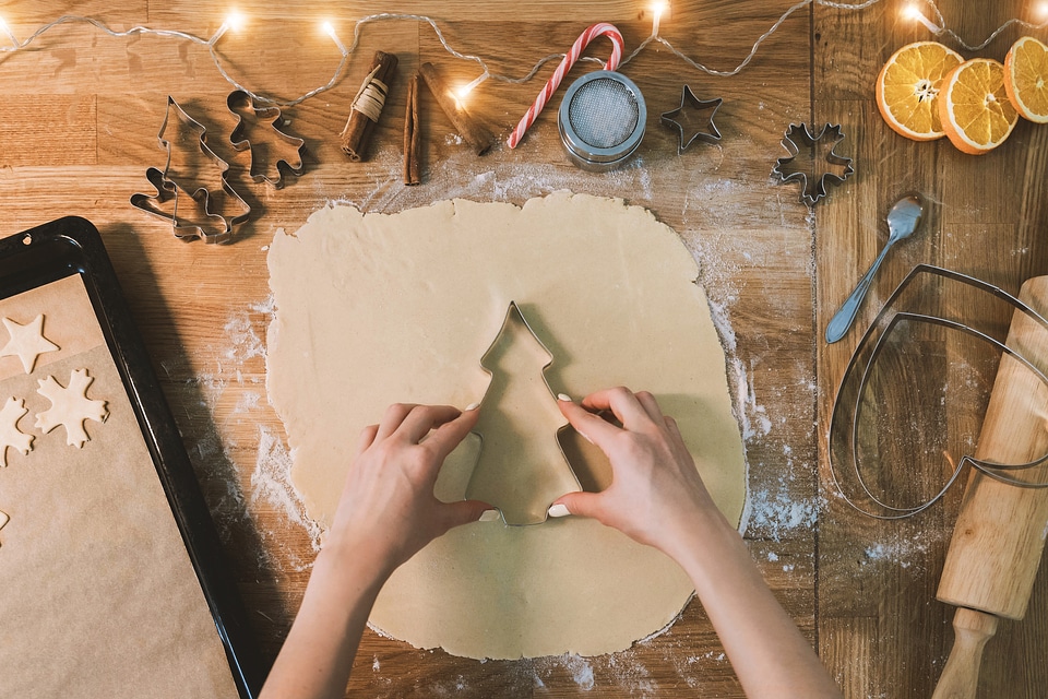 Baking christmas cookies on brown wooden table