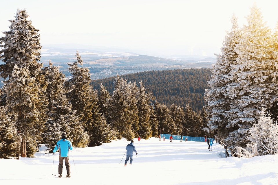 People skiing on a classic downhill track in winter