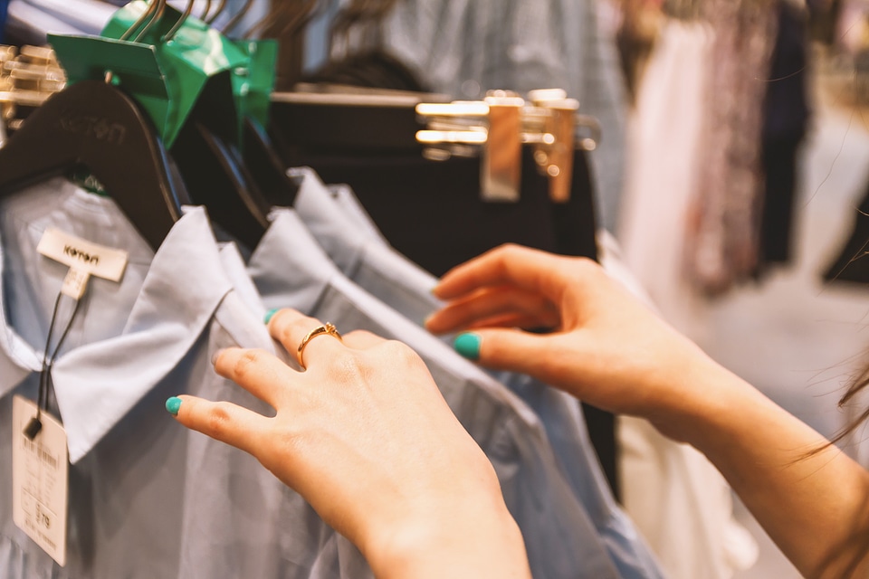 Woman chooses clothes in a store