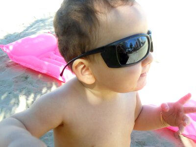 Toy sunglasses sand beach photo
