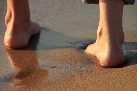 Legs sand sea photo