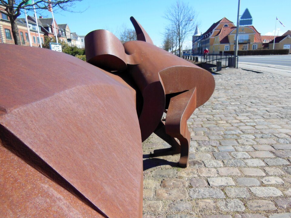 Rust-colored metal sculpture detail picture man