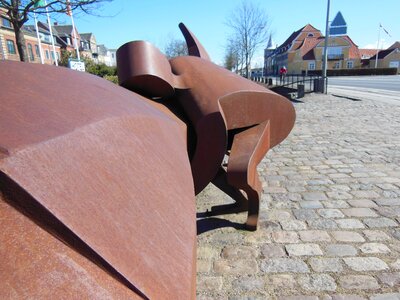 Rust-colored metal sculpture detail picture man