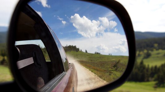 Dirt road clouds rearview photo