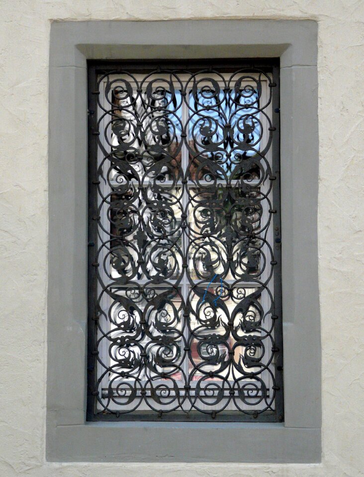 Mirroring wrought iron window grate