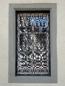 Mirroring wrought iron window grate photo