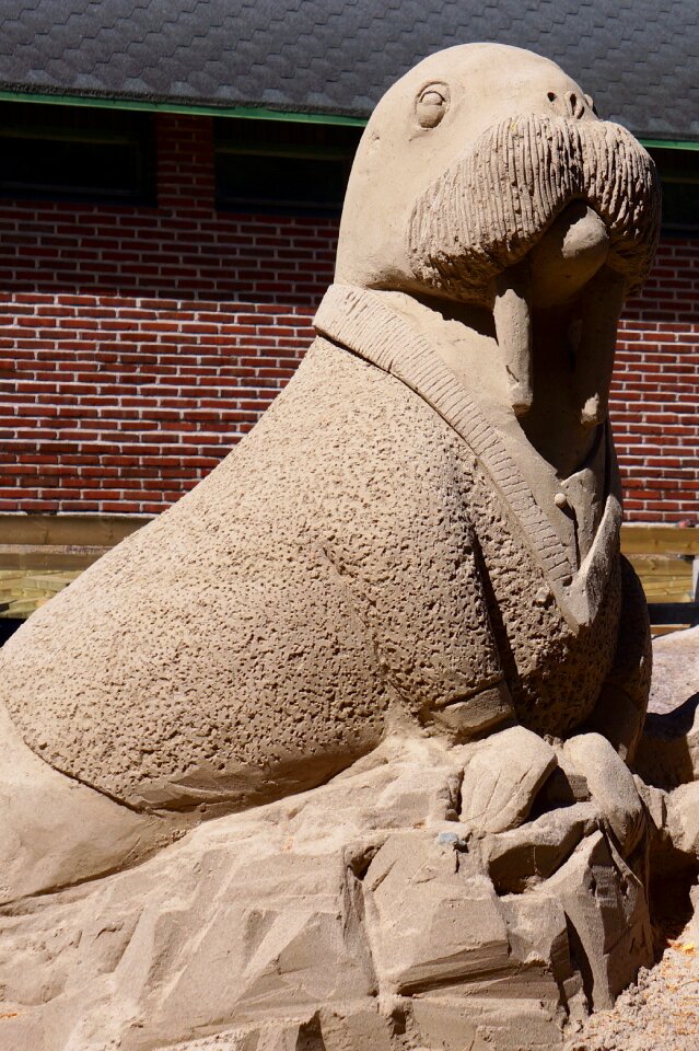 Sand sculpture work of art babe and big teeth